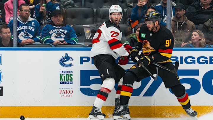 New Jersey Devils defenseman Brett Pesce (22) battles Vancouver Canucks forward Evander Kane (91): Bob Frid-Imagn Images