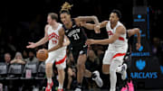 Nov 11, 2025; Brooklyn, New York, USA; Brooklyn Nets forward Noah Clowney (21) brings the ball up court against Toronto Raptors forward Scottie Barnes (4) during the third quarter at Barclays Center. Mandatory Credit: Brad Penner-Imagn Images