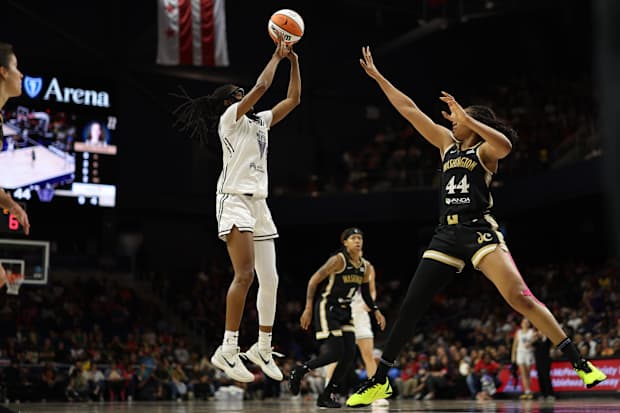 Golden State Valkyries guard Tiffany Hayes shoots the ball as Washington Mystics forward Kiki Iriafen defends. 