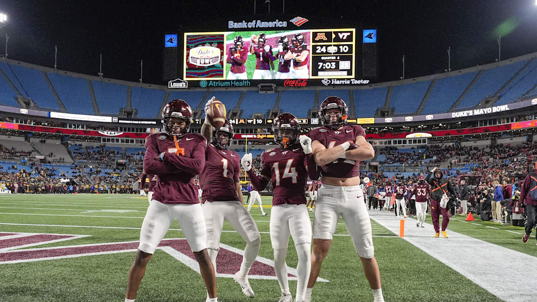 Jan 3, 2025; Charlotte, NC, USA; Virginia Tech Hokies cornerback Dante Lovett (1) and teammates after his late interception during the second half against the Minnesota Golden Gophers at the Duke’s Mayo Bowl at Bank of America Stadium. Mandatory Credit: Jim Dedmon-Imagn Images