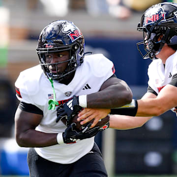 Sep 7, 2024; South Bend, Indiana, USA; Northern Illinois Huskies quarterback Ethan Hampton (2) hands off to running back Antario Brown (1) in the first quarter against the Notre Dame Fighting Irish at Notre Dame Stadium. Mandatory Credit: Matt Cashore-Imagn Images