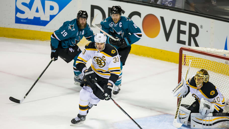 Zdeno Chara (33) clears the puck while Joe Thornton (19) gives chase in 2016. | John Hefti-Imagn Images