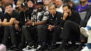 Rapper 50 Cent sits courtside with Sacramento Kings chairman Vivek Ranadive for a game against the Los Angeles Clippers.