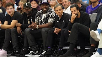 Rapper 50 Cent sits courtside with Sacramento Kings chairman Vivek Ranadive for a game against the Los Angeles Clippers.