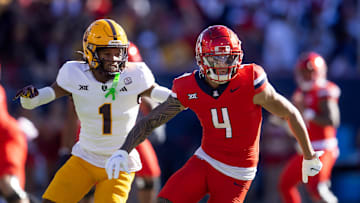 Nov 30, 2024; Tucson, Arizona, USA; Arizona Wildcats wide receiver Tetairoa McMillan (4) against Arizona State Sun Devils defensive back Keith Abney II (1) during the Territorial Cup at Arizona Stadium. 