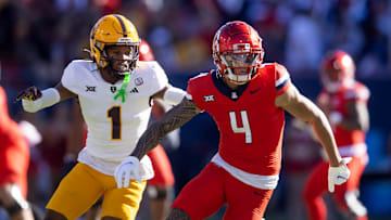 Nov 30, 2024; Tucson, Arizona, USA; Arizona Wildcats wide receiver Tetairoa McMillan (4) against Arizona State Sun Devils defensive back Keith Abney II (1) during the Territorial Cup at Arizona Stadium. Mandatory Credit: Mark J. Rebilas-Imagn Images