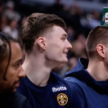 Mar 25, 2024; Denver, Colorado, USA; Denver Nuggets center Nikola Jokic (15) looks on with guard Christian Braun (0) and center DeAndre Jordan (6) in the fourth quarter against the Memphis Grizzlies at Ball Arena. 