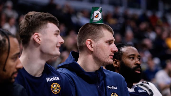 Mar 25, 2024; Denver, Colorado, USA; Denver Nuggets center Nikola Jokic (15) looks on with guard Christian Braun (0) and center DeAndre Jordan (6) in the fourth quarter against the Memphis Grizzlies at Ball Arena. 