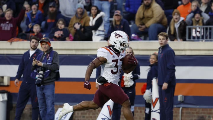 Nov 25, 2023; Charlottesville, Virginia, USA; Virginia Tech Hokies running back Bhayshul Tuten (33) scores a touchdown against the Virginia Cavaliers during the second quarter at Scott Stadium. Mandatory Credit: Geoff Burke-USA TODAY Sports