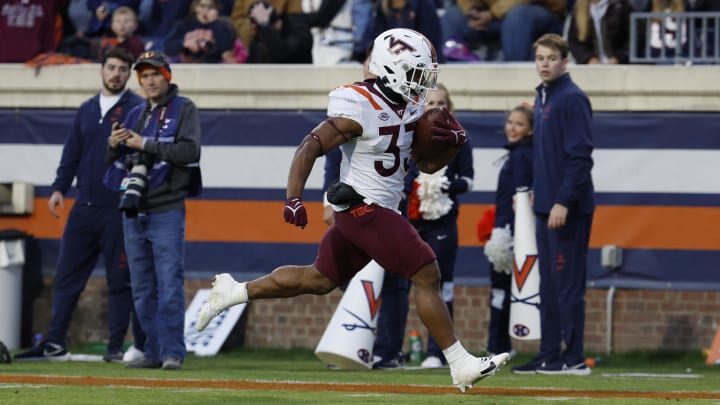 Nov 25, 2023; Charlottesville, Virginia, USA; Virginia Tech Hokies running back Bhayshul Tuten (33) scores a touchdown against the Virginia Cavaliers during the second quarter at Scott Stadium. Mandatory Credit: Geoff Burke-USA TODAY Sports