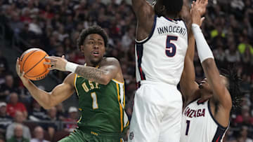 March 10, 2025; Las Vegas, NV, USA; San Francisco Dons guard Malik Thomas (1) is defended by Gonzaga Bulldogs forward Emmanuel Innocenti (5) and guard Michael Ajayi (1) during the second half in the semifinal of the West Coast Conference tournament at Orleans Arena. Mandatory Credit: Kyle Terada-Imagn Images