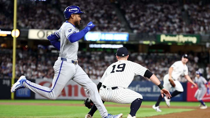 Oct 7, 2024; Bronx, New York, USA; Kansas City Royals third base Maikel Garcia (11) beat the throw to first to hit a single against the New York Yankees in the third inning during game two of the ALDS for the 2024 MLB Playoffs at Yankee Stadium. Mandatory Credit: Vincent Carchietta-Imagn Images