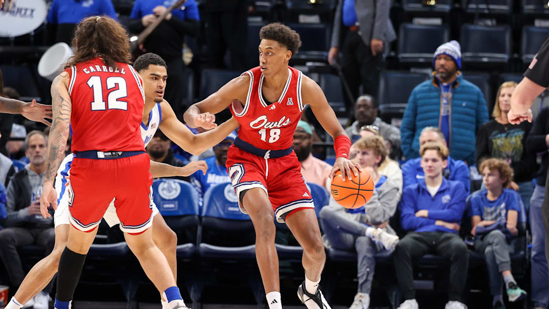 Feb 23, 2025; Memphis, Tennessee, USA; Florida Atlantic Owls forward Baba Miller (18) dribbles against Memphis Tigers forward Nicholas Jourdain (2) during the first half at FedExForum. Mandatory Credit: Wesley Hale-Imagn Images