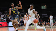 Mar 6, 2024; Coral Gables, Florida, USA; Miami Hurricanes guard Paul Djobet (10) drives to the basket against Boston College Eagles forward Devin McGlockton (21) during the second half at Watsco Center. 