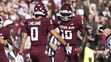 Nov 15, 2025; College Station, Texas, USA; Texas A&M Aggies quarterback Marcel Reed (10) celebrates with wide receiver Izaiah Williams (0) after an Aggies touchdown during the third quarter against the South Carolina Gamecocks at Kyle Field. Mandatory Credit: Troy Taormina-Imagn Images