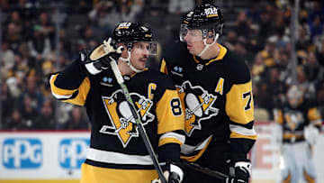 Nov 27, 2024; Pittsburgh, Pennsylvania, USA;  Pittsburgh Penguins center Sidney Crosby (87) and center Evgeni Malkin (71) talk before a face-off against the Vancouver Canucks during the third period at PPG Paints Arena. Mandatory Credit: Charles LeClaire-Imagn Images