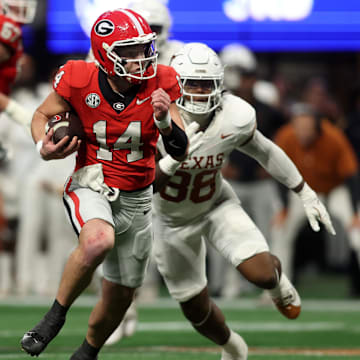 Dec 7, 2024; Atlanta, GA, USA; Georgia Bulldogs quarterback Gunner Stockton (14) rushes the ball against the Texas Longhorns during the second half in the 2024 SEC Championship game at Mercedes-Benz Stadium. Mandatory Credit: Brett Davis-Imagn Images