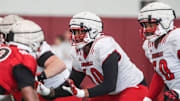 The Louisville offensive and defensive line during practice 