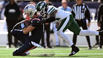 Oct 27, 2024; Foxborough, Massachusetts, USA; New England Patriots quarterback Drake Maye (10) is tackled by New York Jets linebacker Jamien Sherwood (44) during the first half at Gillette Stadium.