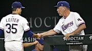 Aug 23, 2025; Arlington, Texas, USA; Texas Rangers manager Bruce Bochy (15) shakes the hand of starting pitcher Jack Leiter (35) as Leiter walks off the field after the seventh inning against the Cleveland Guardians at Globe Life Field.