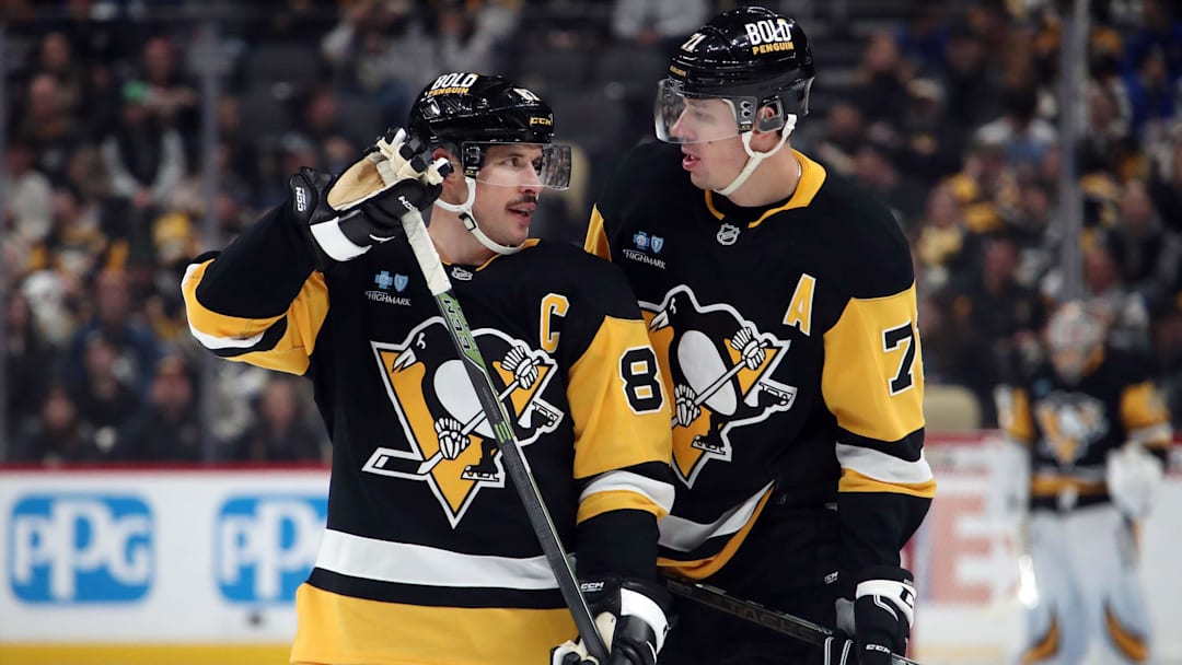 Nov 27, 2024; Pittsburgh, Pennsylvania, USA;  Pittsburgh Penguins center Sidney Crosby (87) and center Evgeni Malkin (71) talk before a face-off against the Vancouver Canucks during the third period at PPG Paints Arena. Mandatory Credit: Charles LeClaire-Imagn Images