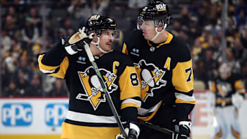 Nov 27, 2024; Pittsburgh, Pennsylvania, USA;  Pittsburgh Penguins center Sidney Crosby (87) and center Evgeni Malkin (71) talk before a face-off against the Vancouver Canucks during the third period at PPG Paints Arena. Mandatory Credit: Charles LeClaire-Imagn Images