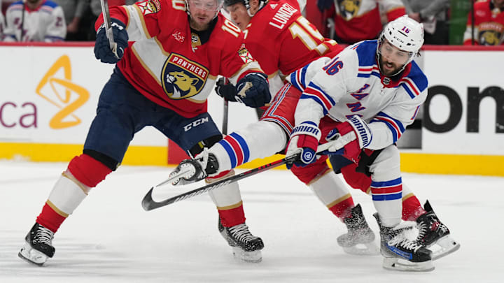 Jun 1, 2024; Sunrise, Florida, USA; New York Rangers center Vincent Trocheck (16) collides with Florida Panthers center Anton Lundell (15) and right wing Vladimir Tarasenko (10) during the first period in game six of the Eastern Conference Final of the 2024 Stanley Cup Playoffs at Amerant Bank Arena. Mandatory Credit: Jim Rassol-Imagn Images