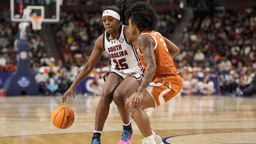 Mar 9, 2025; Greenville, SC, USA; South Carolina Gamecocks guard Raven Johnson (25) handles the ball against Texas Longhorns guard Rori Harmon (3) during the second half at Bon Secours Wellness Arena. Mandatory Credit: Jim Dedmon-Imagn Images