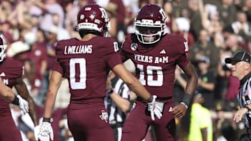 Texas A&M quarterback Marcel Reed celebrates with wide receiver Izaiah Williams after an Aggies touchdown.