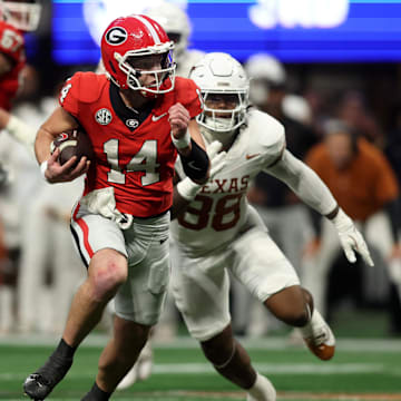 Dec 7, 2024; Atlanta, GA, USA; Georgia Bulldogs quarterback Gunner Stockton (14) rushes the ball against the Texas Longhorns during the second half in the 2024 SEC Championship game at Mercedes-Benz Stadium. Mandatory Credit: Brett Davis-Imagn Images