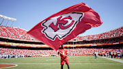 Aug 17, 2024; Kansas City, Missouri, USA; A Kansas City Chiefs staff member waves a large flag against the Detroit Lions after a Chiefs score during the first half at GEHA Field at Arrowhead Stadium. Mandatory Credit: Denny Medley-Imagn Images