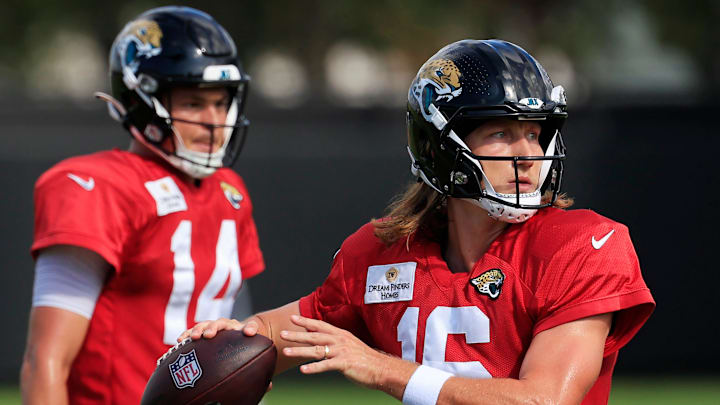 Jacksonville Jaguars quarterback Trevor Lawrence (16) looks to pass as quarterback Nick Mullens (14) looks on during an NFL training camp session at the Miller Electric Center, Thursday, Aug. 14, 2025 in Jacksonville, Fla.