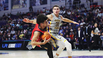 Cayden Boozer of the Miami Columbus High School basketball team drives to the basket during the championship game against Montverde at the City of Palms Classic at Suncoast Credit Union Arena in Fort Myers on Monday, Dec. 23, 2024. He is defended by Dante Allen of Montverde Academy. Miami Columbus won.