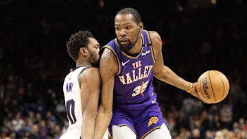 Mar 14, 2025; Phoenix, Arizona, USA; Phoenix Suns forward Kevin Durant (35) dribbles the ball against Sacramento Kings guard Malik Monk (0) during the first half at Footprint Center. Mandatory Credit: Mark J. Rebilas-Imagn Images