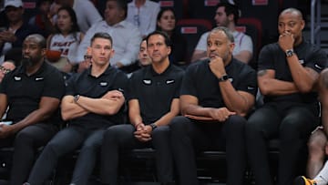Apr 28, 2025; Miami, Florida, USA; Miami Heat associate head coach Chris Quinn (left), head coach Erik Spoelstra (center), assistant coach Malik Allen and assistant coach Caron Butler (right) look on from the bench against the Cleveland Cavaliers in the fourth quarter during game four for the first round of the 2025 NBA Playoffs at Kaseya Center. Mandatory Credit: Sam Navarro-Imagn Images