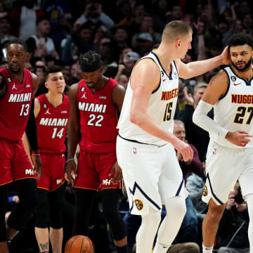 Denver Nuggets guard Jamal Murray (27) celebrates his basket with center Nikola Jokic (15) and forward Aaron Gordon (50) in the fourth quarter against the Miami Heat at Ball Arena. 