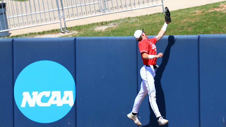 May 30, 2025; Oxford, MS, USA;  Western Kentucky Hilltoppers outfielder Ryan Wideman (33) attempts to save a three home run hit by Georgia Tech Yellowjackets pitcher/infielder Alex Hernandez (4) during the first inning. Mandatory Credit: Petre Thomas-Imagn Images