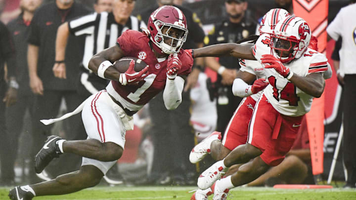 Aug 31, 2024; Tuscaloosa, Alabama, USA; Alabama Crimson Tide wide receiver Kendrick Law (1) runs the ball for a touchdown against Western Kentucky Hilltoppers safety Devonte' Mathews (14) during the first half at Bryant-Denny Stadium. Mandatory Credit: Gary Cosby Jr.-Imagn Images
