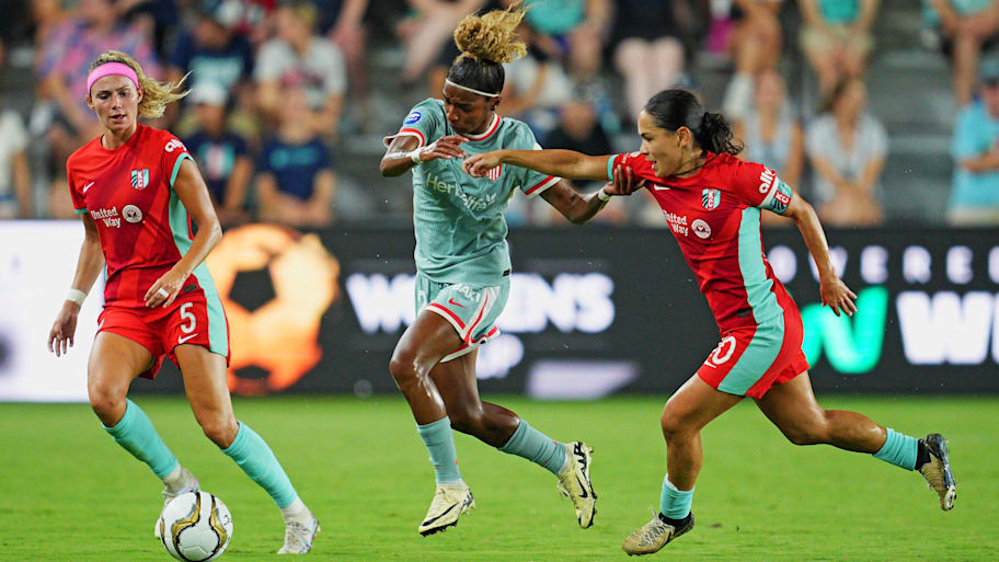 Kansas City Current defender Ellie Wheeler and midfielder Lo'eau LaBonta go for the ball against Luany.