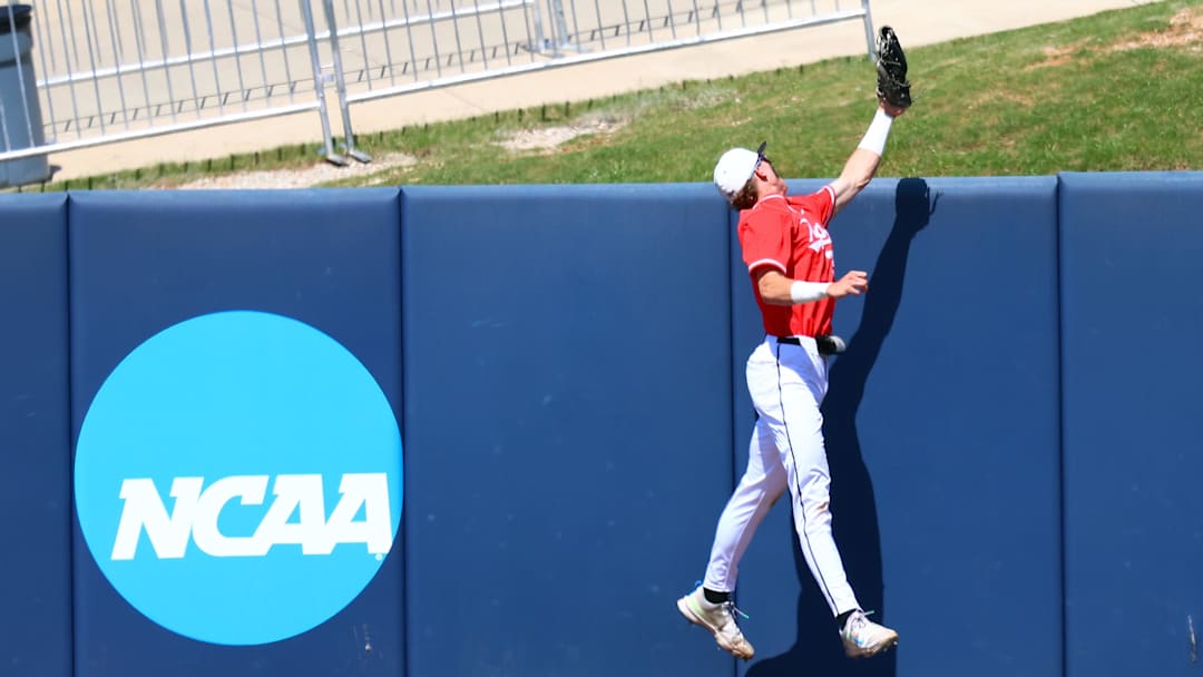 May 30, 2025; Oxford, MS, USA;  Western Kentucky Hilltoppers outfielder Ryan Wideman (33) attempts to save a three home run hit by Georgia Tech Yellowjackets pitcher/infielder Alex Hernandez (4) during the first inning. Mandatory Credit: Petre Thomas-Imagn Images