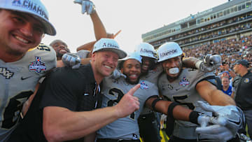 Dec 2, 2017; Orlando, FL, USA; UCF Knights head coach Scott Frost celebrates with players after defeating the Memphis Tigers in double overtime at Spectrum Stadium. Mandatory Credit: Matt Stamey-Imagn Images