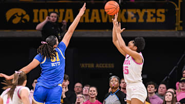 Feb 23, 2025; Iowa City, Iowa, USA; Iowa Hawkeyes forward Hannah Stuelke (45) shoots the ball over UCLA Bruins center Lauren Betts (51) during the second quarter at Carver-Hawkeye Arena. Mandatory Credit: Jeffrey Becker-Imagn Images