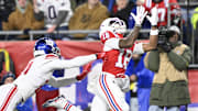 Dec 1, 2025; Foxborough, Massachusetts, USA; New England Patriots wide receiver Kyle Williams (18) catches a pass for a touchdown against New York Giants cornerback Paulson Adebo (21) during the second quarter at Gillette Stadium. Mandatory Credit: Eric Canha-Imagn Images
