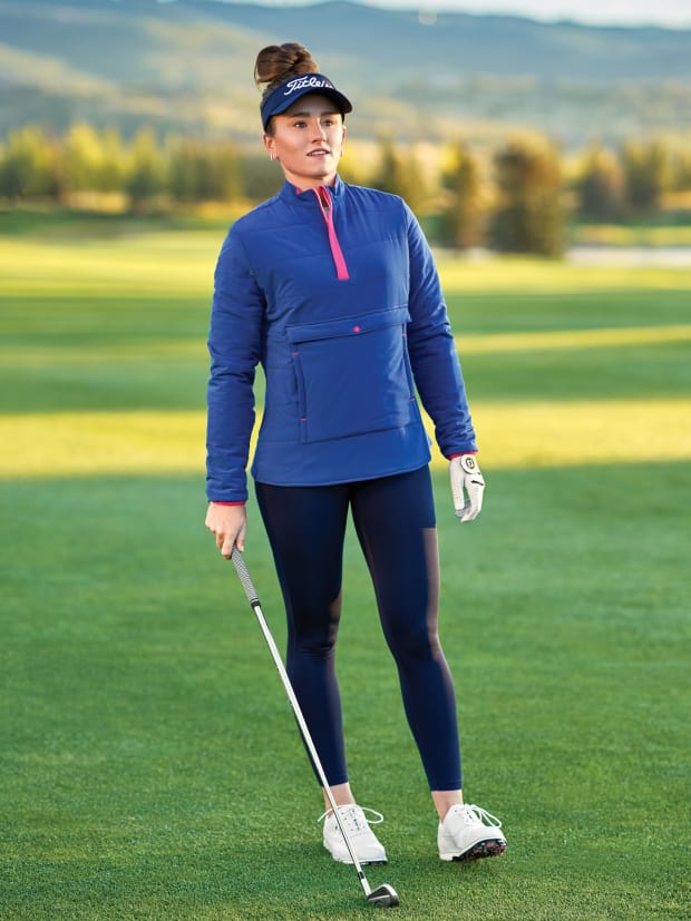 A woman models FootJoy golf apparel.