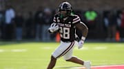 Nov 30, 2024; Lubbock, Texas, USA;  Texas Tech Red Raiders running back Tahj Brooks (28) carries the ball against the West Virginia Mountaineers in the first half at Jones AT&T Stadium and Cody Campbell Field. Mandatory Credit: Michael C. Johnson-Imagn Images