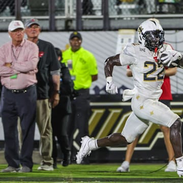 Aug 28, 2025; Orlando, Florida, USA; UCF Knights running back Myles Montgomery (22) runs the ball during the second quarter against the Jacksonville State Gamecocks at Acrisure Bounce House. Mandatory Credit: Mike Watters-Imagn Images