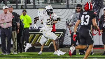 Aug 28, 2025; Orlando, Florida, USA; UCF Knights running back Myles Montgomery (22) runs the ball during the second quarter against the Jacksonville State Gamecocks at Acrisure Bounce House. Mandatory Credit: Mike Watters-Imagn Images