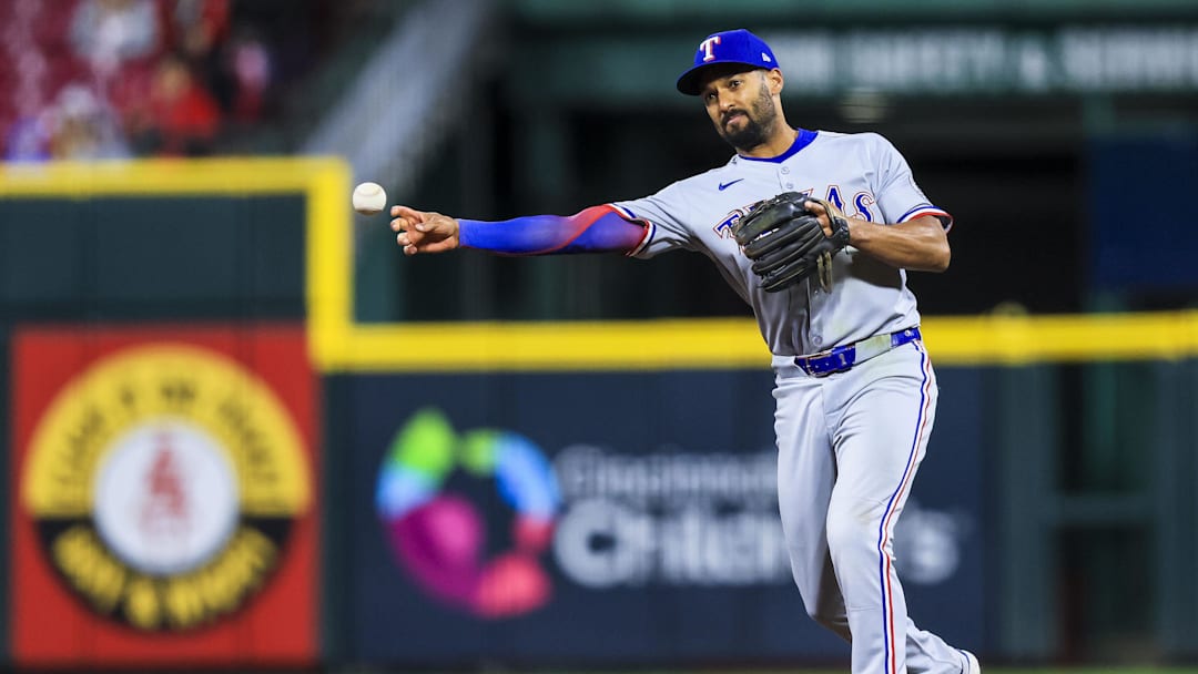 Mar 31, 2025; Cincinnati, Ohio, USA; Texas Rangers second baseman Marcus Semien (2) throws to first to get Cincinnati Reds third baseman Santiago Espinal (not pictured) out in the eighth inning at Great American Ball Park. / Katie Stratman-Imagn Images