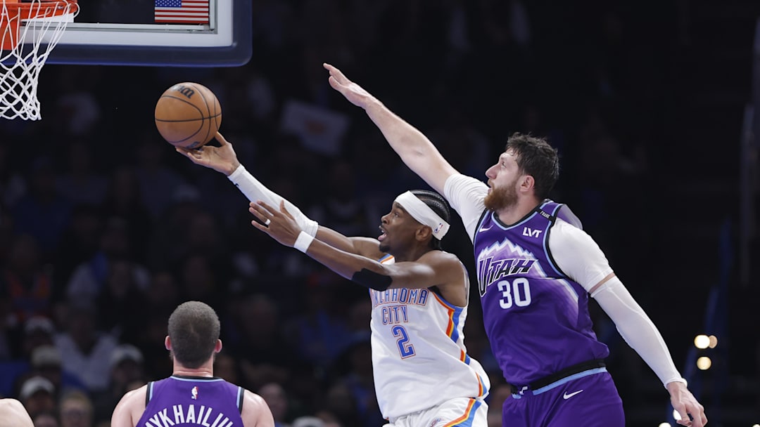 Jan 7, 2026; Oklahoma City, Oklahoma, USA; Oklahoma City Thunder guard Shai Gilgeous-Alexander (2) goes up for a basket in front of Utah Jazz center Jusuf Nurkić (30) during the second half at Paycom Center. Mandatory Credit: Alonzo Adams-Imagn Images