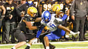 Oct 19, 2022; Boone, North Carolina, USA;  Georgia State Panthers wide receiver Cadarrius Thompson (11) fumbles the ball after Appalachian State Mountaineers linebacker Caden Sullivan (26) makes a tackle with Mountaineers linebacker Kyle Arnholt (56) closing in during the second half at Kidd Brewer Stadium. Mandatory Credit: Reinhold Matay-Imagn Images